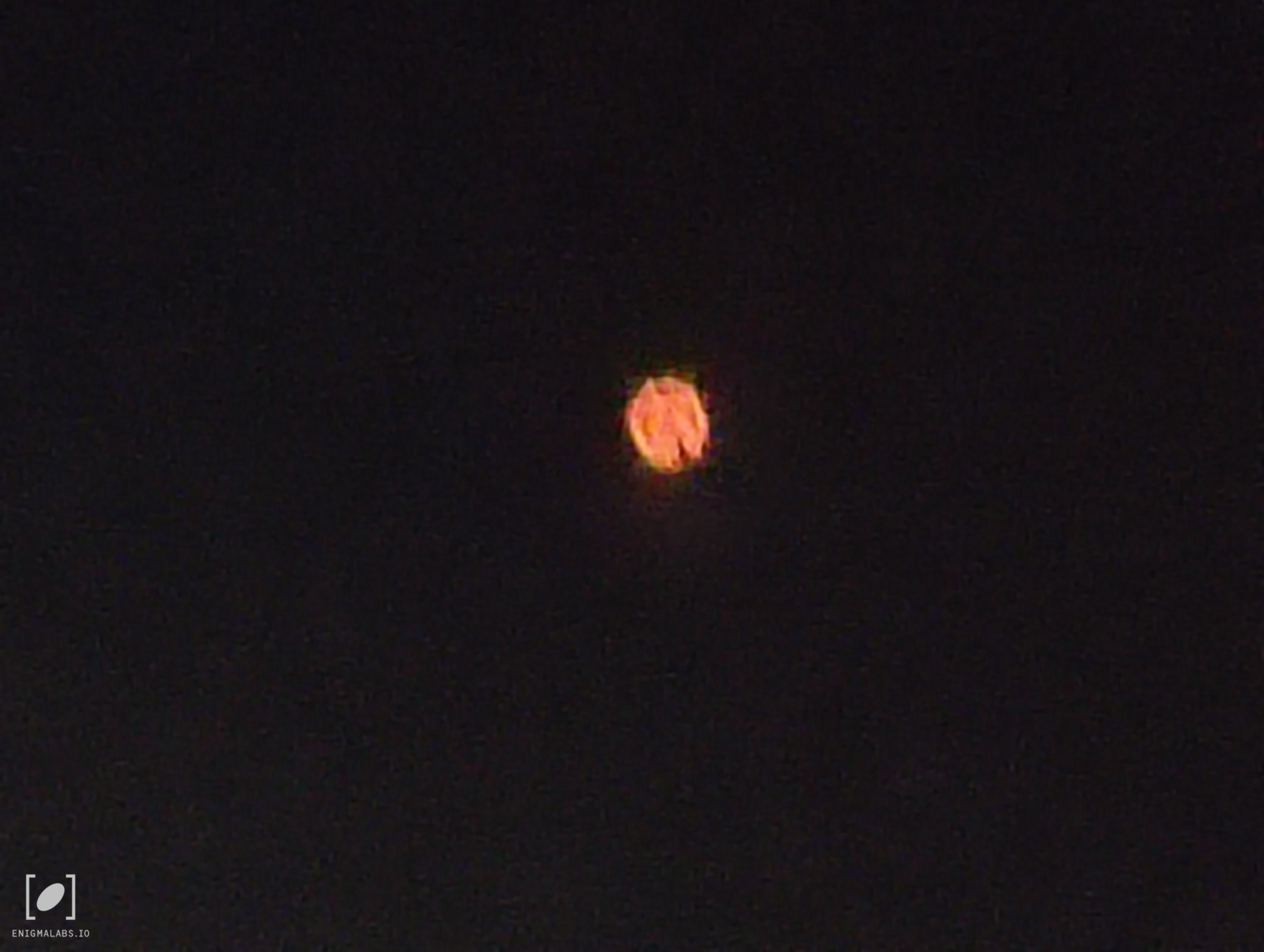 Missoula MT UAP photo 1 — orange-red orb against black sky