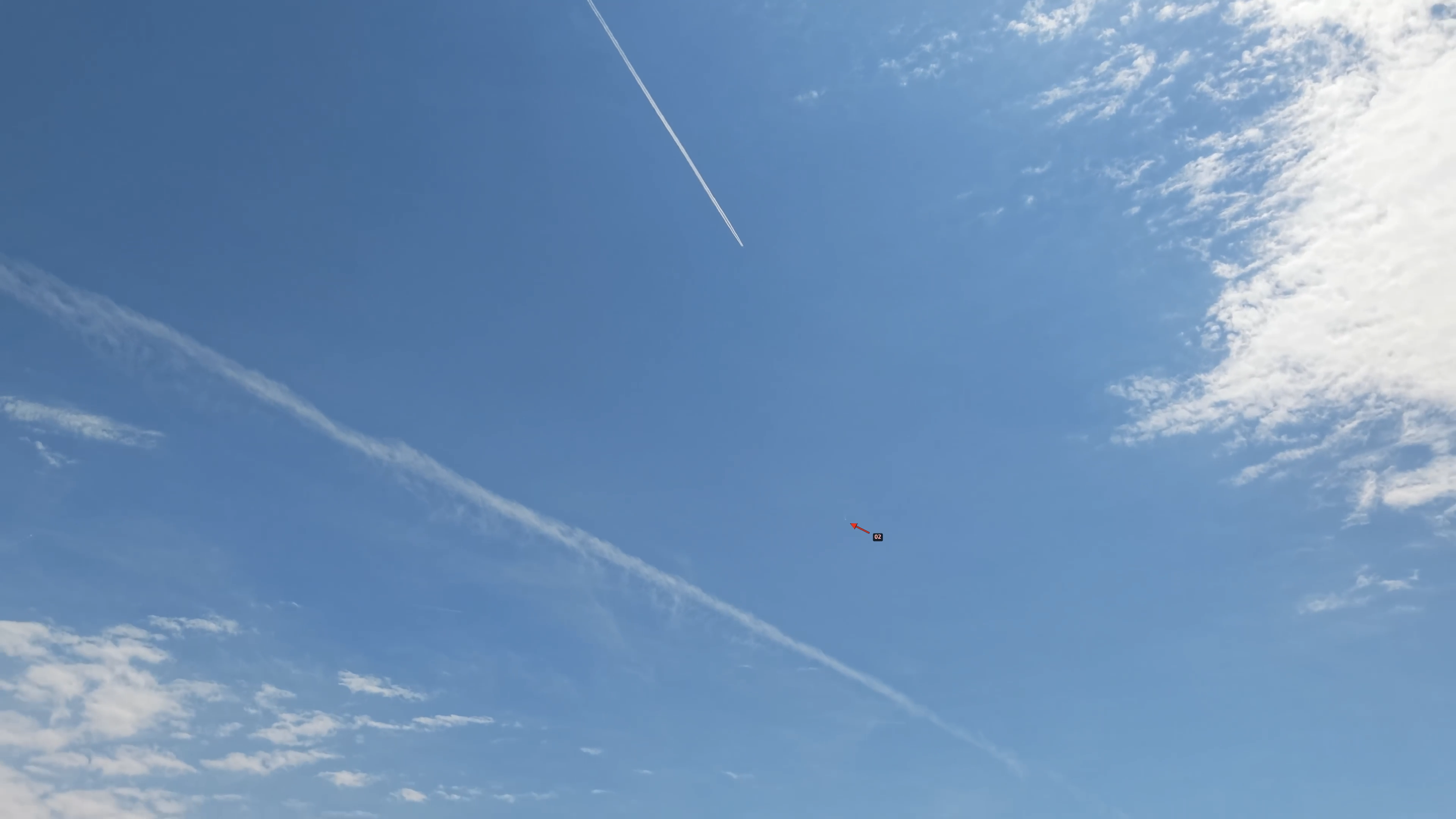 Frame showing contrail trace with arrow near it